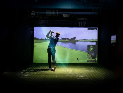 Golfer in a finished golf simulator