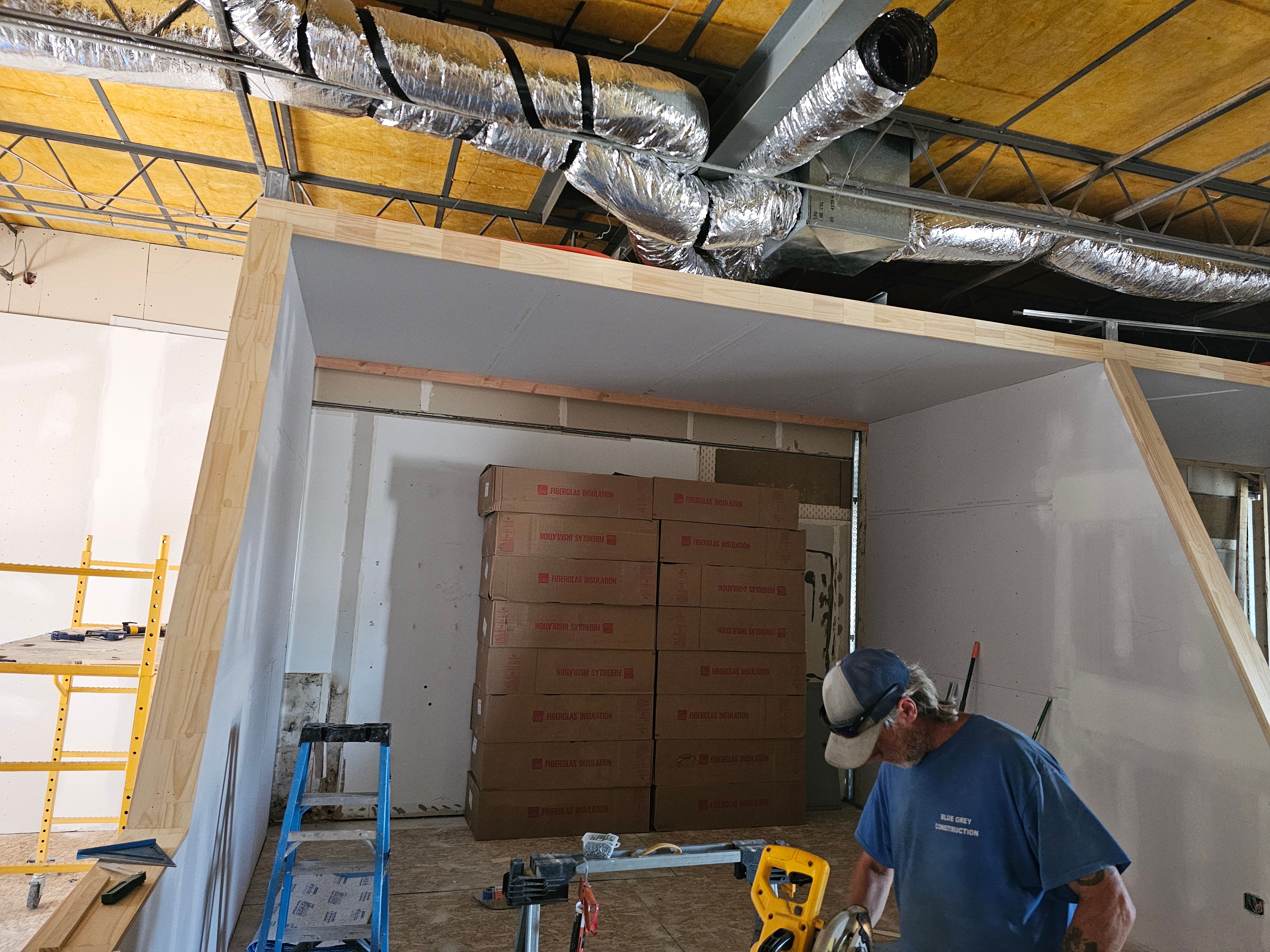 Framing and drywall going up around a simulator bay at All Seasons Indoor Golf Club