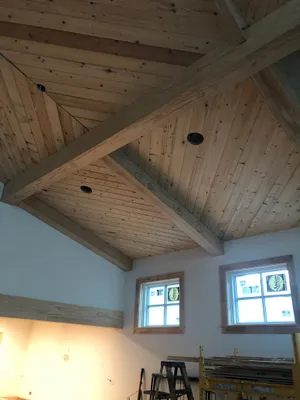 Custom tongue-and-groove wood ceiling with exposed beams