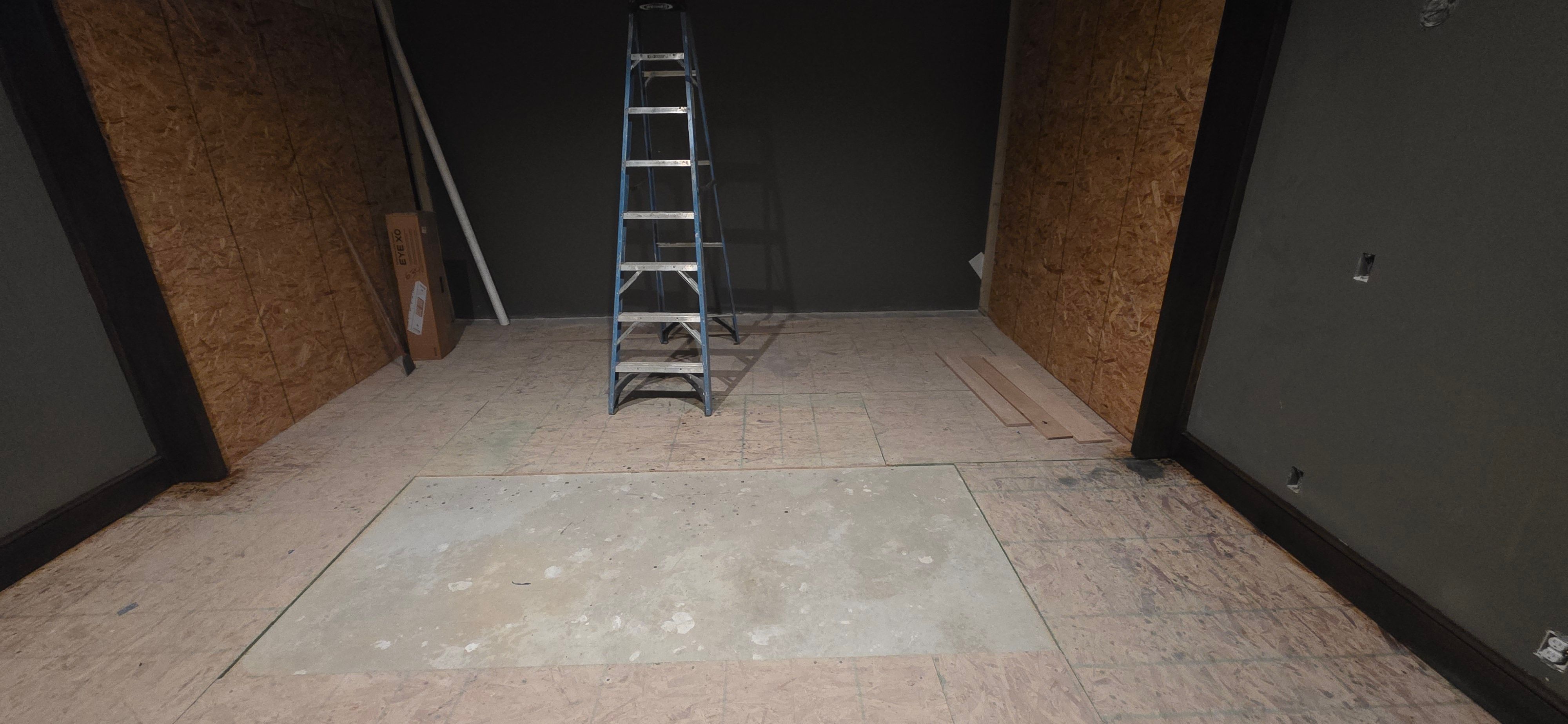 Subfloor and wall framing going in for the basement golf simulator in the Grain Valley home