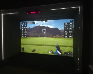Finished and calibrated golf simulator bay with LED lighting and an overhead launch monitor